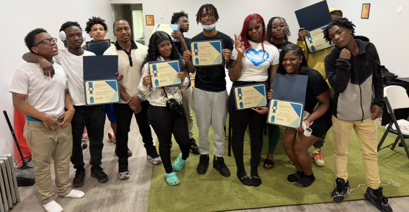 CyberSecure Teens students holding their certificates of completion with their instructor